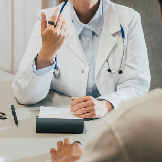 Doctor talking to patient while wearing Oura ring