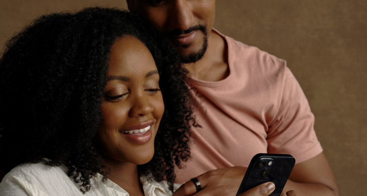 People looking at phone while wearing Oura ring