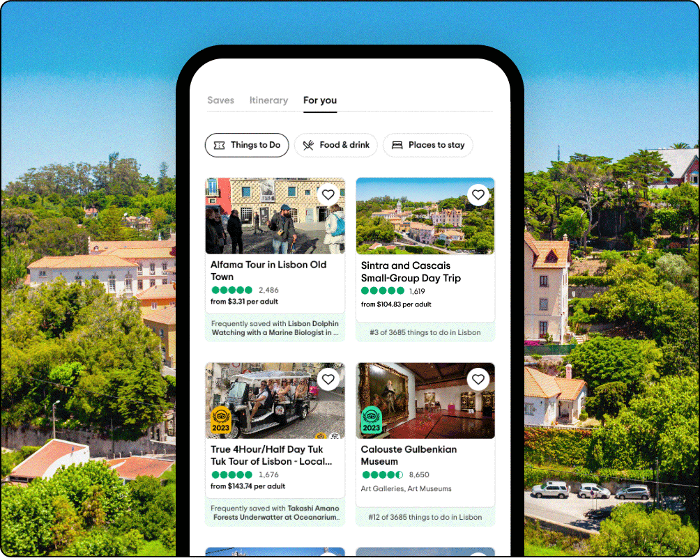 Image Description: Phone screen graphic overlaid on a scenic photo. The phone shows a person's trip in the For You tab with recommended tours and attractions.