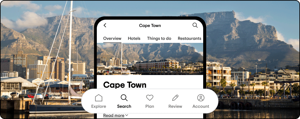 Image Description: Landscape view of Cape Town from the water with the downtown in the foreground and rocky mountains just beyond. A phone screen is overlaid showing the destination page on Tripadvisor for Cape Town with navigation icons popped out.