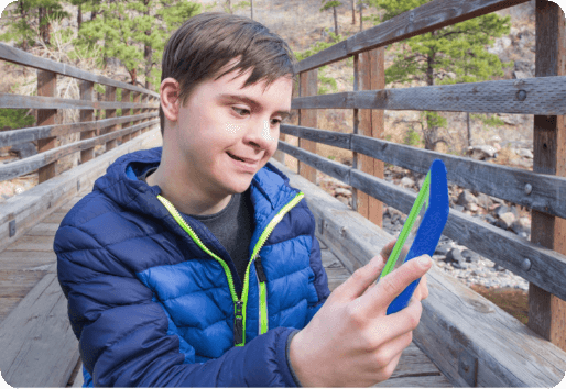 A kid using their tablet outside