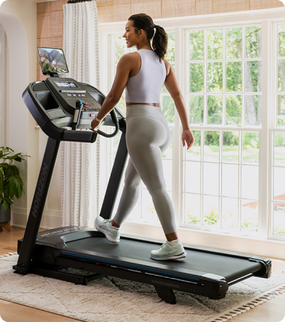 Woman walking on a Horizon treadmill at home Woman walking on a Horizon treadmill at home