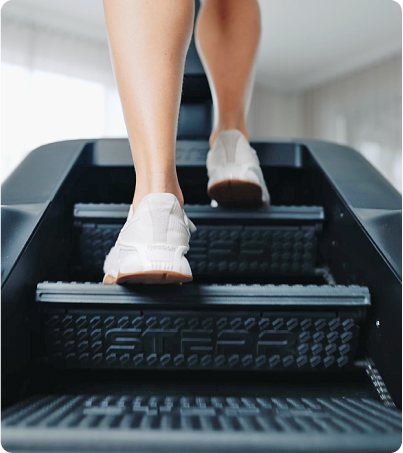 Close up low angle of female legs using STEPR Stair Climber Close up low angle of female legs using STEPR Stair Climber
