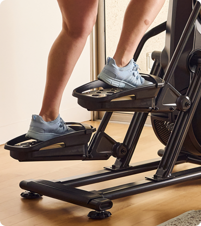 Close-up of female legs climbing on BowFlex Max Trainer