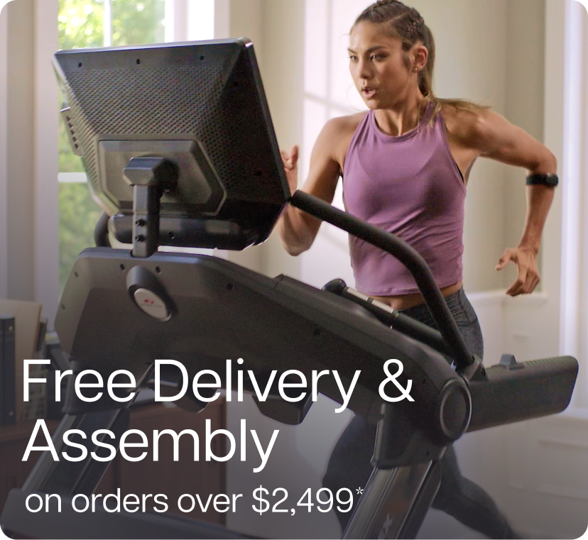 Woman in purple tank top running on BowFlex Treadmill 22 Woman in purple tank top running on BowFlex Treadmill 22