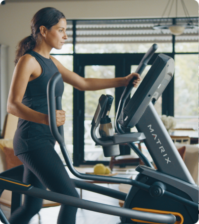 Female in black leggings and black tank top working out on Matrix ascent trainer. Female in black leggings and black tank top working out on Matrix ascent trainer.