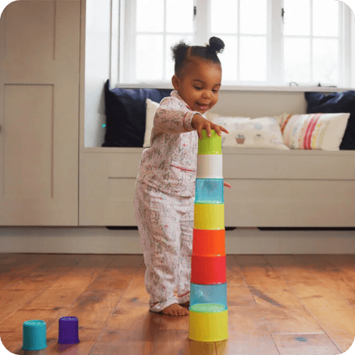 a toddler playing a stacking game