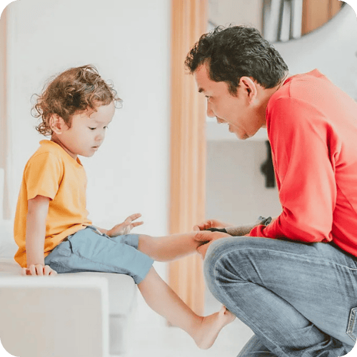 sad kid talking to dad who is avoiding 6 phrases to never say to toddlers