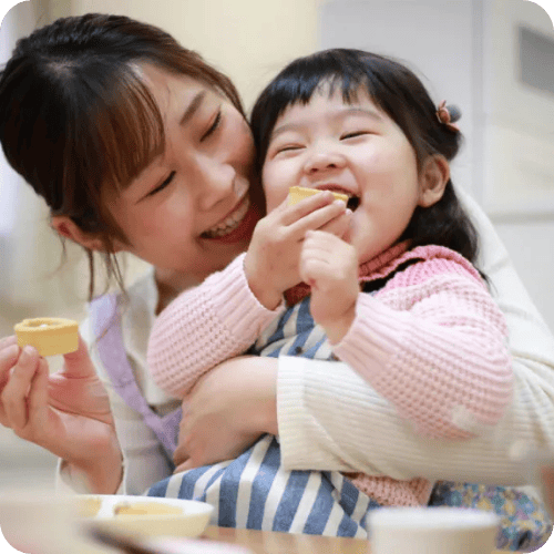 a mom and toddler daughter eating healthy toddler snacks