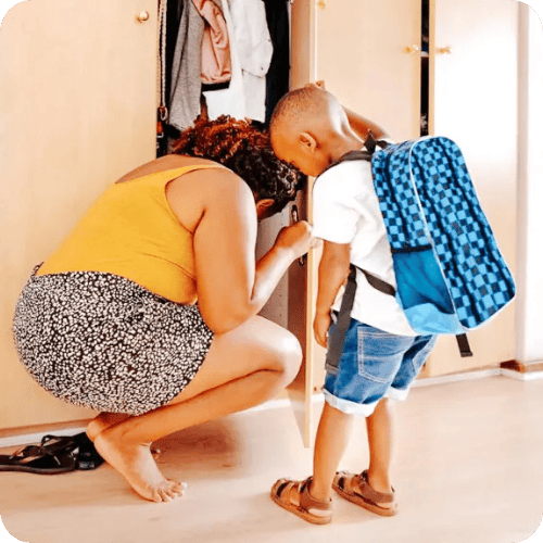 little boy getting ready to leave the house with mom using a getting out of the house routine