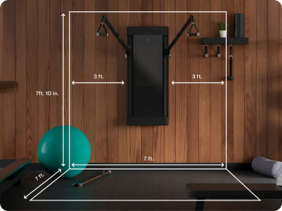 Home gym with mounted Tonal on the wall showing the 7'x7'x7.1' minimal space requirement 