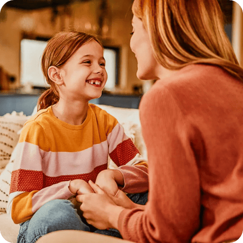 mom and daughter talking on the couch