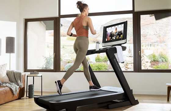 Woman running on NordicTrack Treadmill in living room