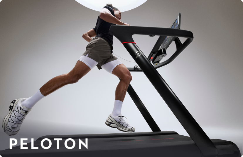 Man running on Peloton Cross Training Tread in bright studio