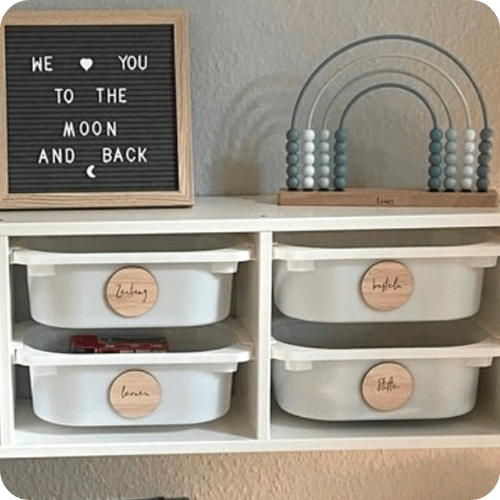 An IKEA shelf with labelled bins is one of the best ikea hacks for kids rooms