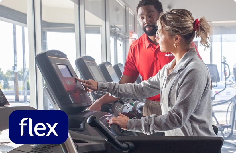 Johnson associate showing female customer Matrix treadmill in showroom Johnson associate showing female customer Matrix treadmill in showroom