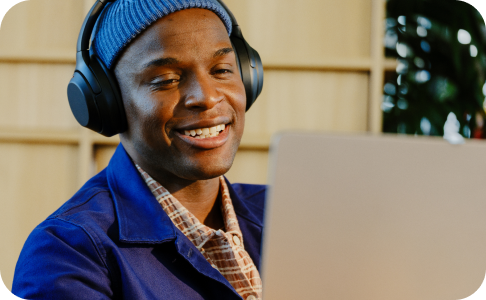 Man smiling and looking at computer