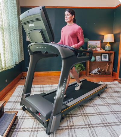 Woman walking on Matrix treadmill at home. Woman walking on Matrix treadmill at home.