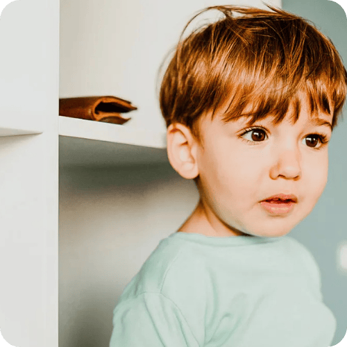 a toddler looking like he doesn't like what he sees