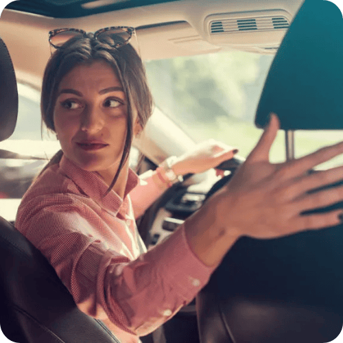 woman looking behind her in the car