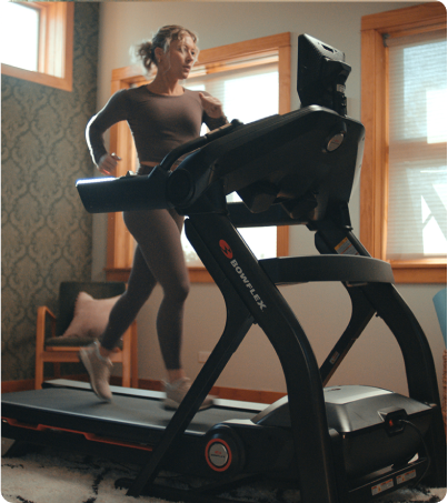 Woman running on Bowflex Treadmill in home