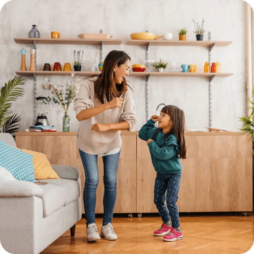 a mom and daughter dancing playing a quick game