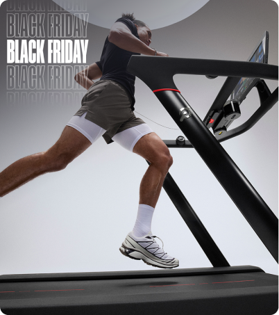 Man running on Peloton Tread in bright studio