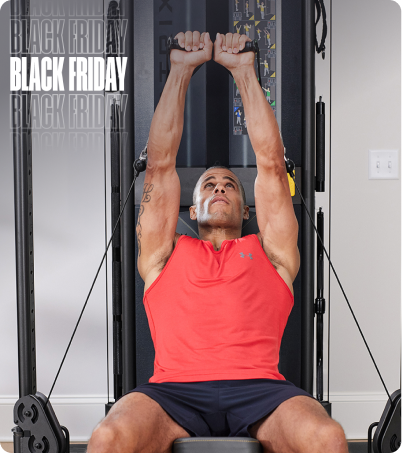 Man in red tank top working out on Matrix FTR30 functional trainer