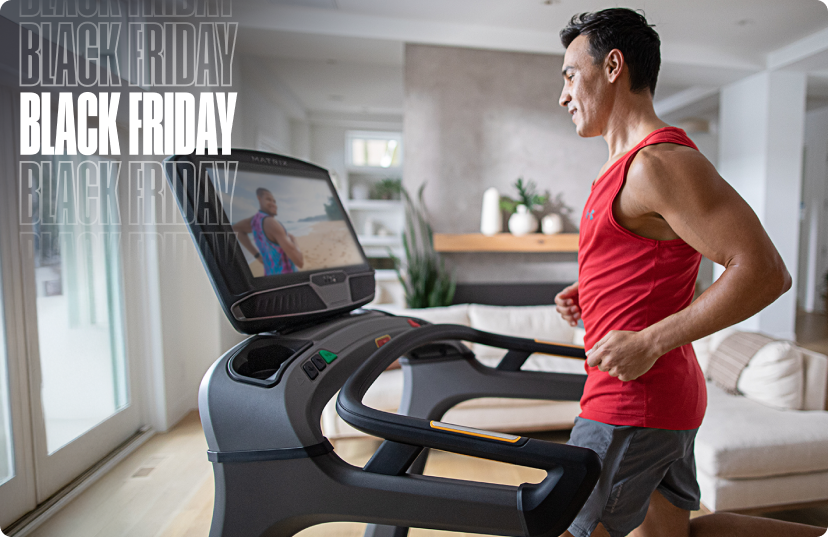 Man running on Matrix Treadmill in bright and sunny home Man running on Matrix Treadmill in bright and sunny home