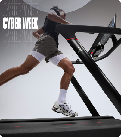 Man running on Peloton Tread in bright studio