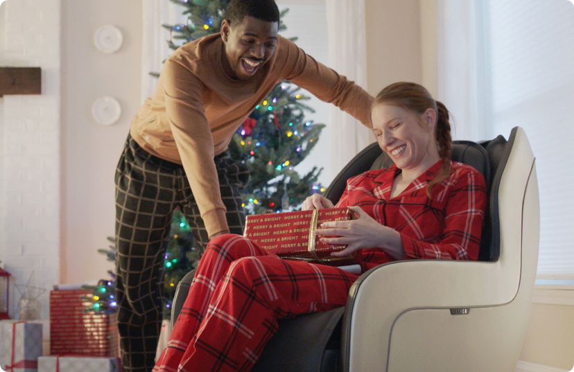 Man and woman opening Christmas presents in their pajamas Man and woman opening Christmas presents in their pajamas
