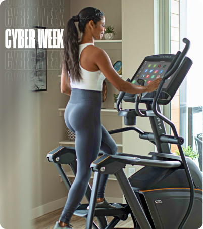 Woman using Matrix A50 Elliptical at home