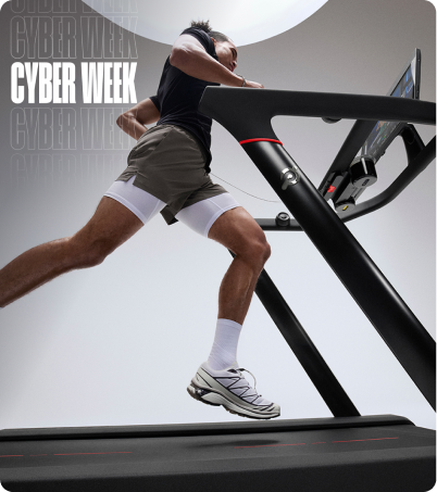 Man running on Peloton Tread in gray studio