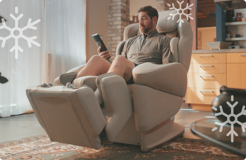 Man relaxing in Synca JP1100 massage chair in home
