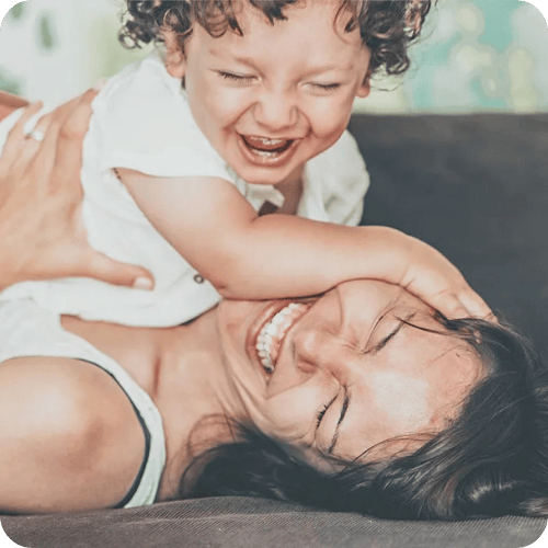 a mom playing with her toddler and laughing