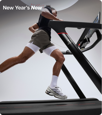 Man running on Peloton Tread in bright grey studio
