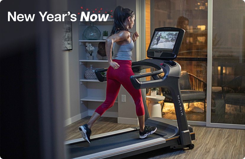 Woman using Matrix Treadmill in home office in the evening