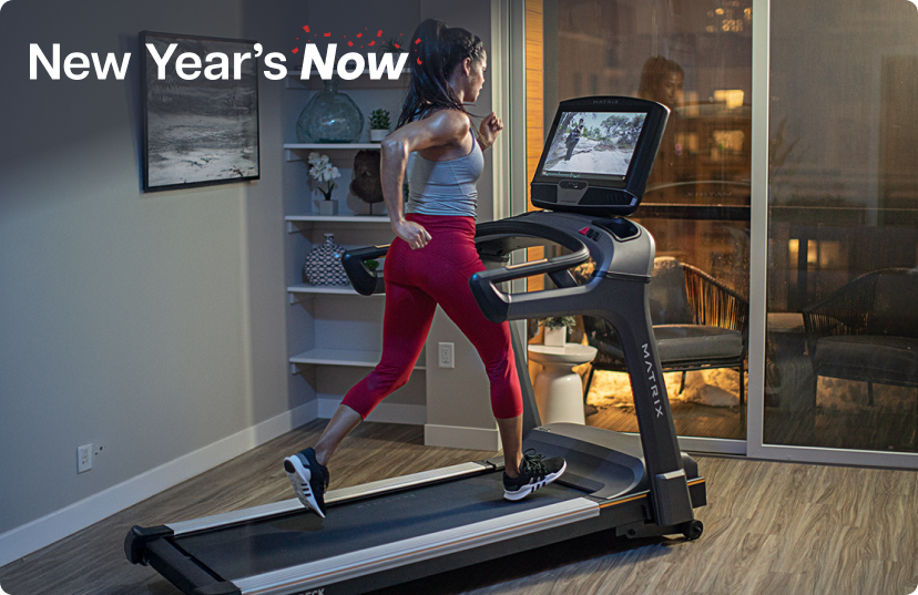 Woman running on Matrix treadmill in the evening