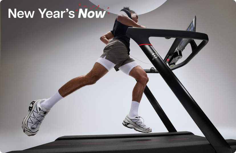 Man running on Peloton Tread in bright gray studio