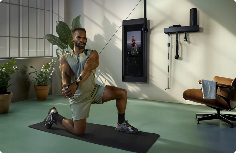 Male athlete using Tonal 2 smart home gym in industrial loft setting