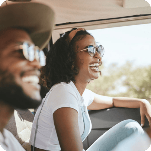 a happy couple driving and laughing
