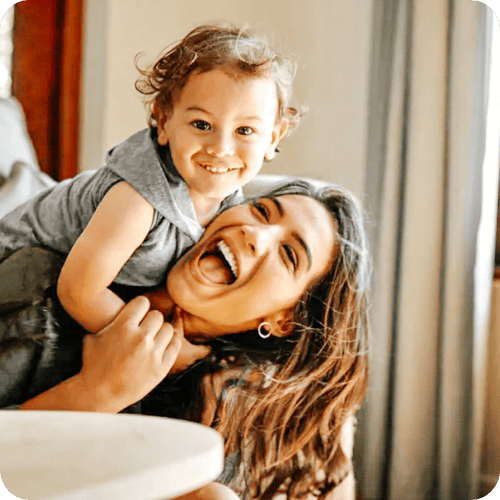 a mom playing with her toddler beaming because she listened to this amazing piece of mom advice