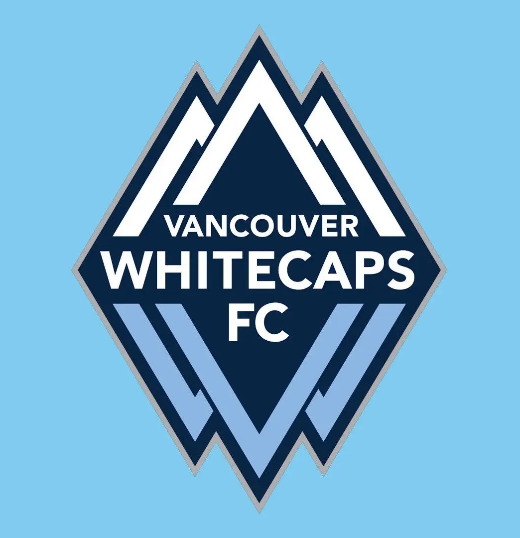 Logo of Vancouver Whitecaps FC featuring stylized mountain peaks in blue and white on a light blue background.