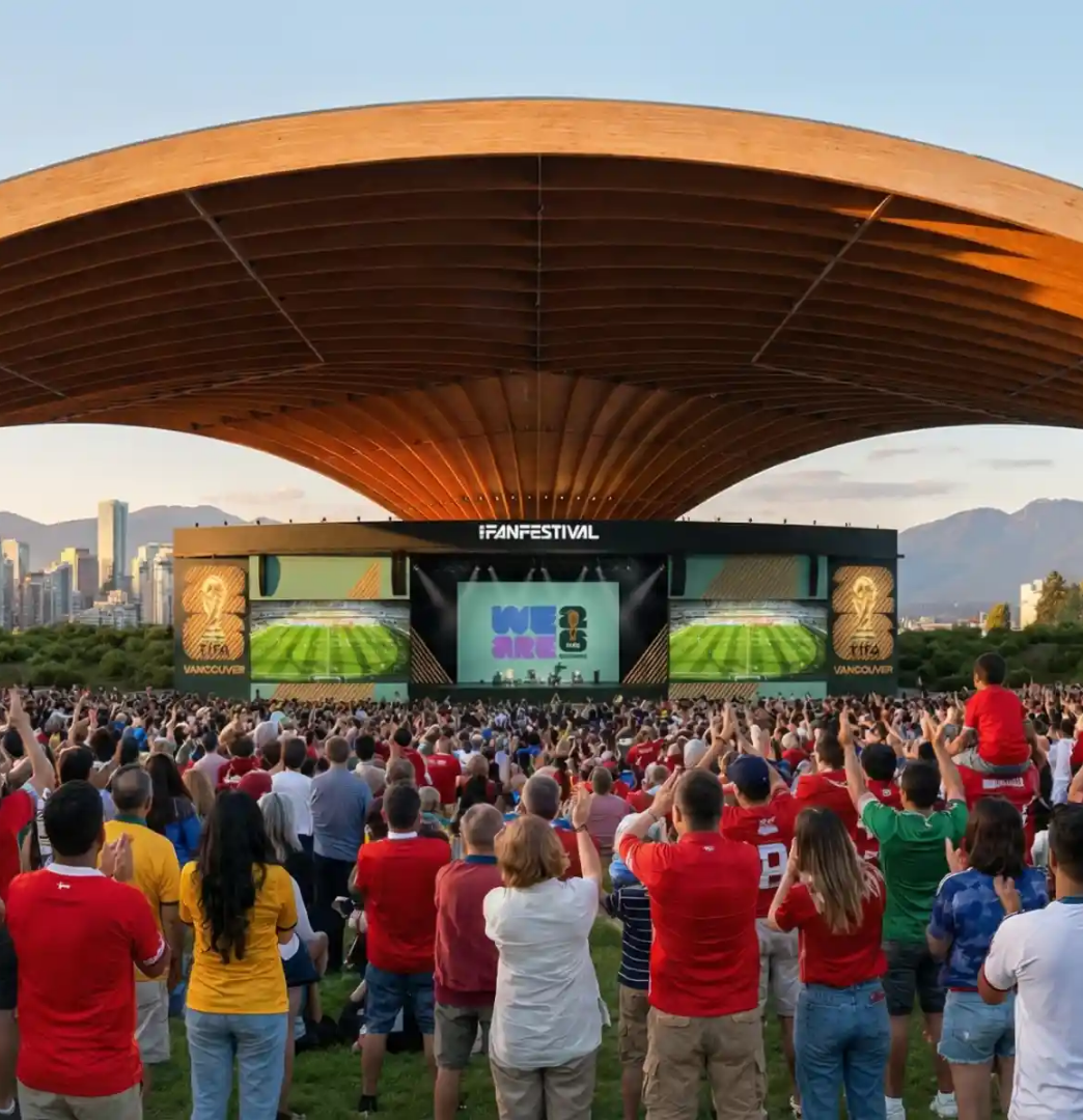 A large crowd gathers at a fan festival in Vancouver, watching a soccer match on big screens.