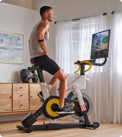 Male riding NordicTrack Tour De France Bike in home