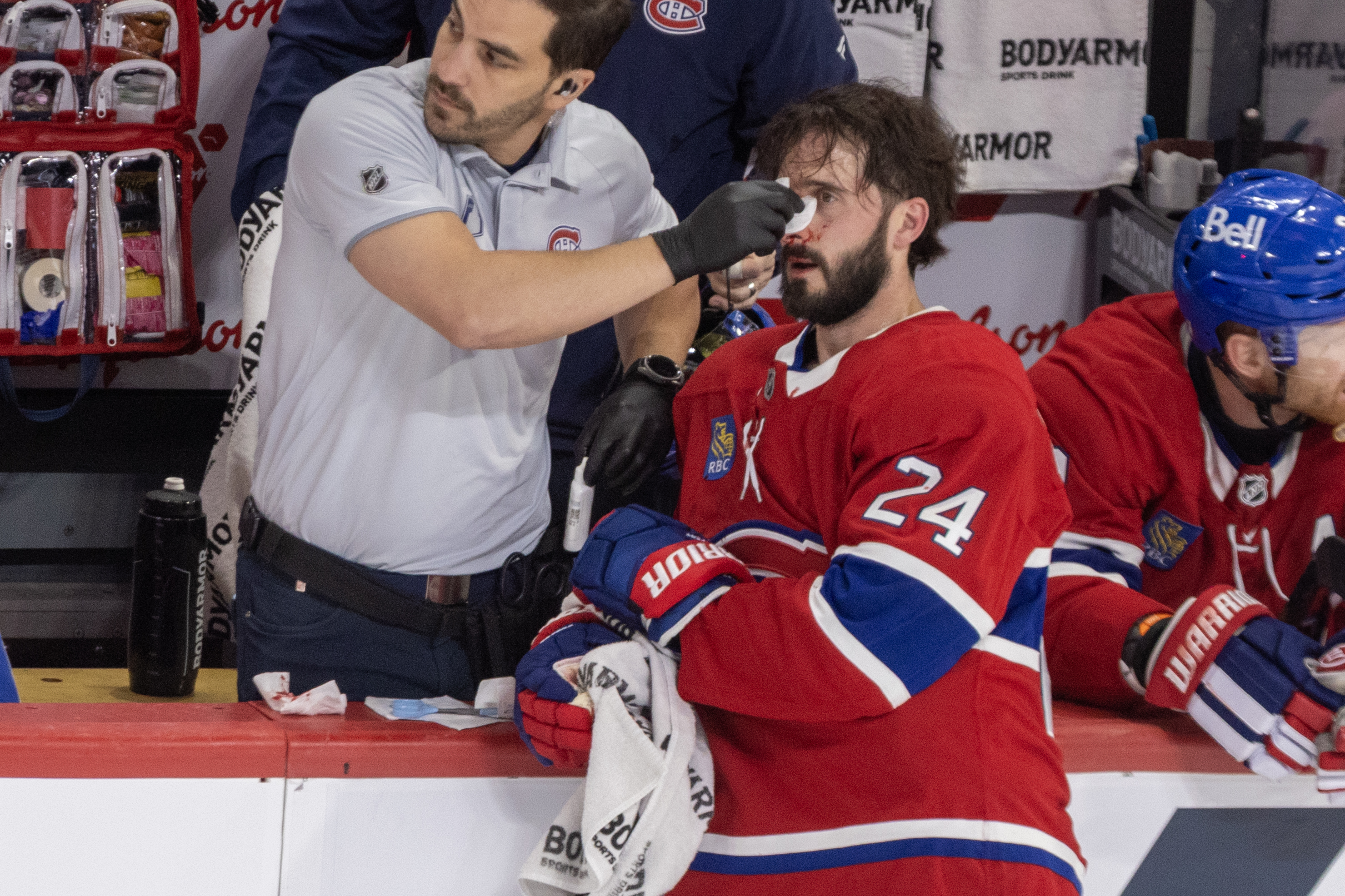 Phil Danault receives medical attention for his bleeding nose in Game 4