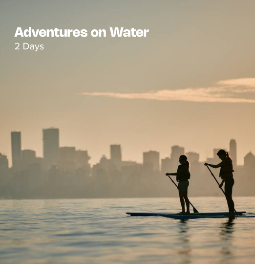 Adventures on Water itinerary cover featuring two people paddleboarding on calm water at sunset with the Vancouver skyline silhouetted in the background.