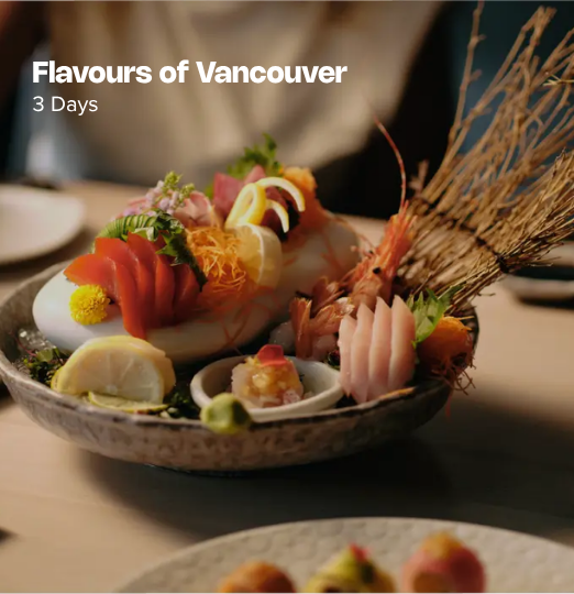 Flavours of Vancouver itinerary cover featuring an artfully plated sushi and sashimi spread with prawns, citrus, and garnishes on a restaurant table in warm lighting.