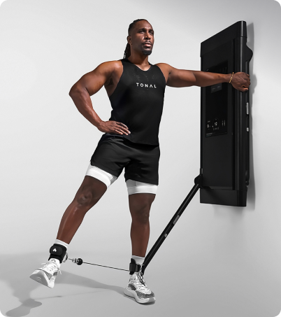 Athletic man doing leg exercises with Tonal 2 Smart Home Gym