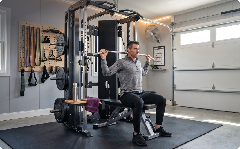 Man doing seated pulldowns on Force USA All-In-One Trainer in home garage